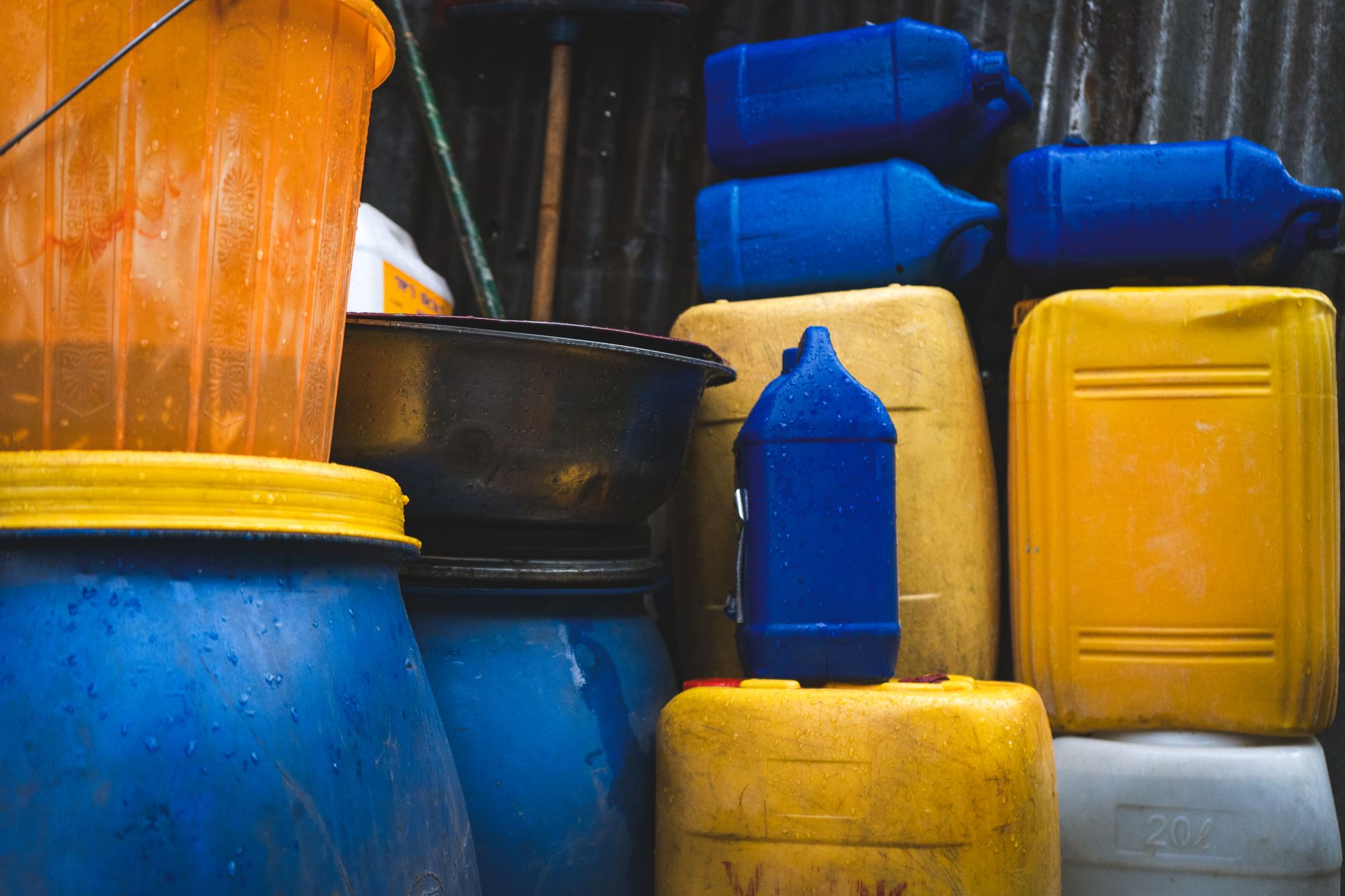 Blue 55-gallon emergency water storage barrel on basement floor